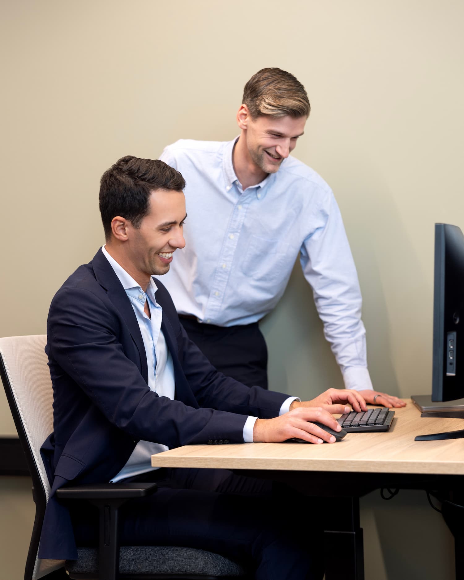 Colleagues working together on the same desk